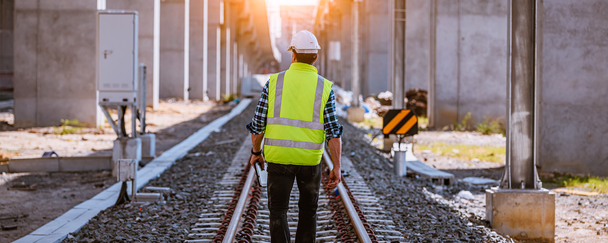 Portrait engineer under inspection and checking construction process railway and checking work on railroad station Engineer wearing safety uniform and safety helmet in work