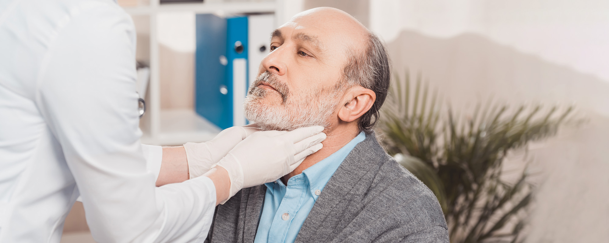 doctor checking patients throat in clinic