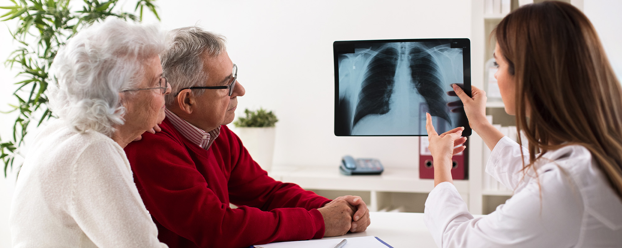 doctor shows results to old patient x ray of the lungs