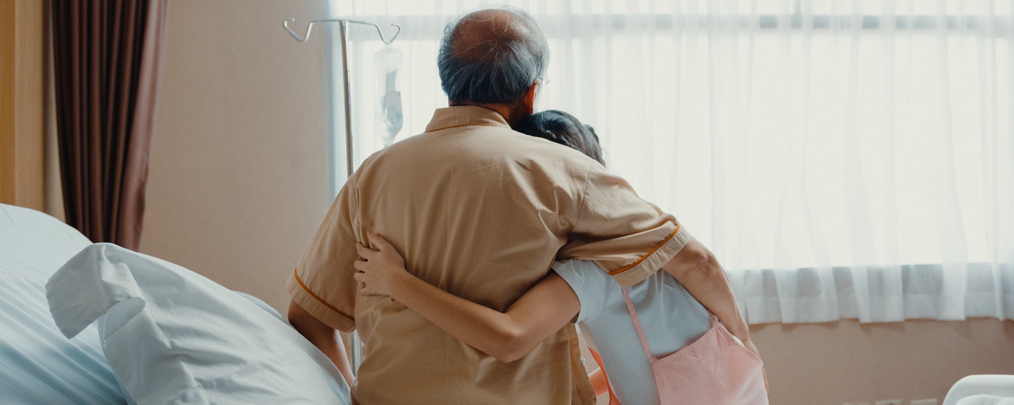 girl Asian granddaughter visiting hug sick senior grandfather
