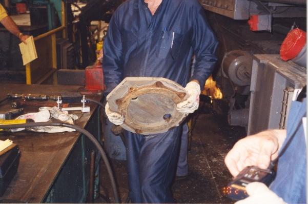 railroad worker lifting a heavy object
