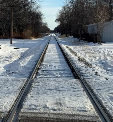 snow and ice on railroad tracks